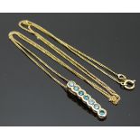 A 9ct gold pendant set with blue diamonds on a 9ct gold chain, 1.6g