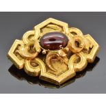 Victorian yellow metal brooch set with a garnet cabochon, 6.6g, 2.8 x 3.5cm