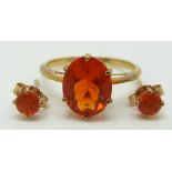 A 9ct gold ring set with an oval cut Mexican fire opal (size L/M) and a pair of earrings set with