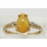 A 9ct gold ring set with a pear cut opal and diamonds, 1.9g, size N