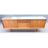 A retro mid century G-Plan style sideboard with two sliding doors either side of four drawers,