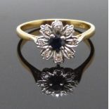An 18ct gold ring set with a sapphire and diamonds in a flower setting, size P, 3.1g