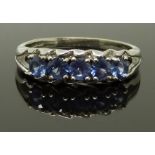 A 9ct white gold ring set with sapphires, size N, 3.70g