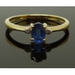 A 9ct gold ring set with an oval cut sapphire and diamonds, size N, 1.63g