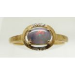 A 9ct gold ring set with an oval black opal cabochon and diamonds, 1.6g, size N