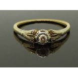 An 18ct gold ring set with a diamond in a platinum setting, size P, 2.21g