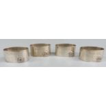 Set of four Indian or similar white metal napkin rings with applied elephants, each marked