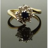 A 9ct gold ring set with a sapphire and diamonds, size L/M, 3.44g