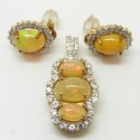 A 9ct gold pendant set with three opal cabochons and white sapphires and a pair of 9ct gold earrings
