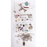 A collection of silver jewellery including snake ring, other rings, necklaces, bangle and earrings