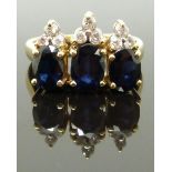 An 18ct gold ring set with three oval cut sapphires and diamonds, 6.6g, size K