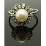 An 18ct white gold ring set with a pearl surrounded by diamonds, size R, 4.89g