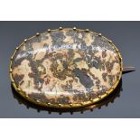 Victorian yellow metal brooch set with an oval agate section, 2.7 x 3.6cm