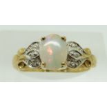 A 9ct gold ring set with an oval opal cabochon and diamonds, 2.4g, size N