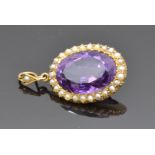 Edwardian 15ct gold pendant set with an oval cut amethyst and seed pearls, 2.2 x 1.7cm