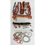 An amber necklace, carnelian necklace, sodalite, coral, French jet, etc
