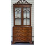 Georgian style glazed display cabinet with two over three graduated serpentine drawers, by repute