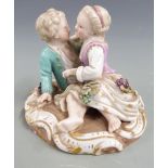 Meissen figure of sweethearts embracing, with applied grape and vine decoration, blue crossed swords