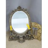 Ornate metal and bevelled glass mirror with integral candle sconces, height 58cm, and a gilt metal