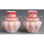 A pair of Thomas Webb pink quilted satin glass vases with gilt decoration and applied clear handles,