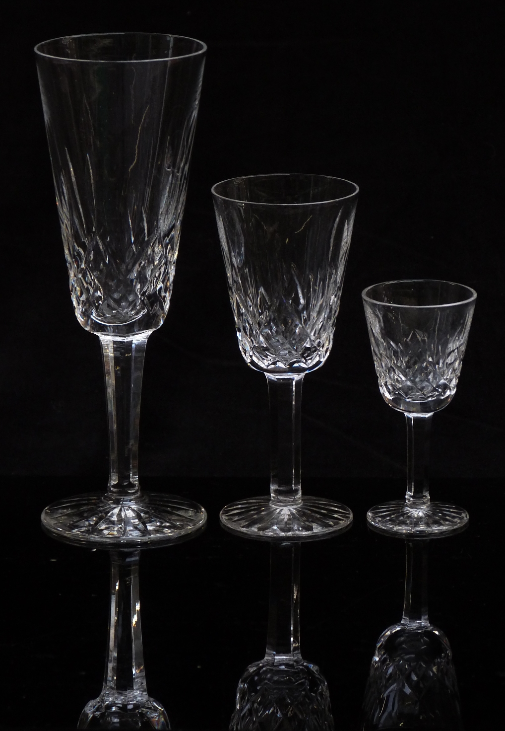 A part suite of Waterford Crystal drinking glasses comprising six white wine, six sherry and six