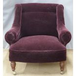 Upholstered armchair raised on turned front legs