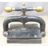 Cast iron book press with brass handles, width 42cm