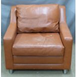 Brown leather armchair raised on brushed stainless steel or similar legs
