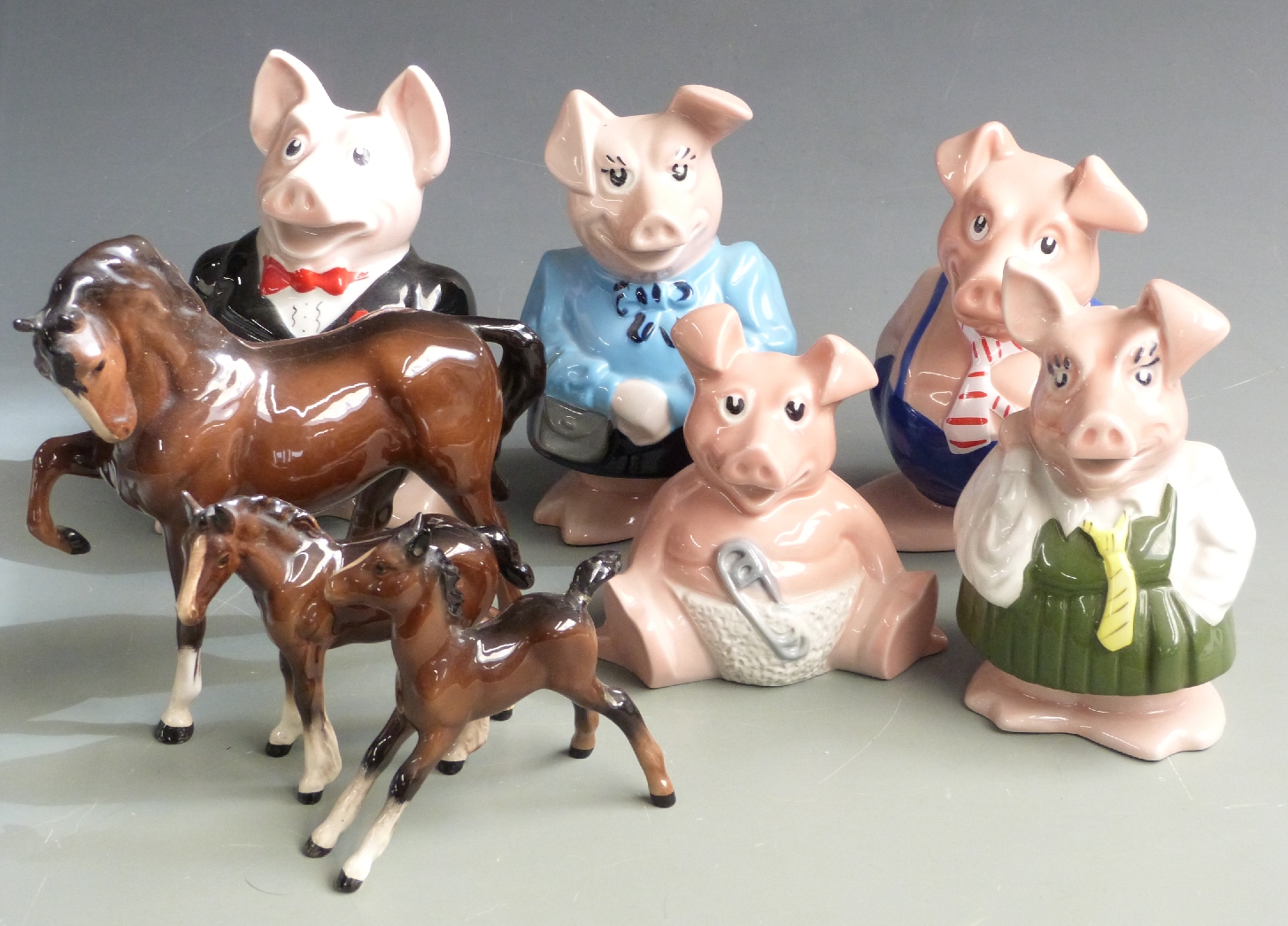 Five Wade Nat West pigs and three Beswick horses, tallest 18cm