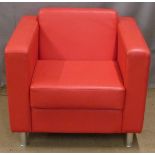 Red faux leather armchair raised on tubular metal feet