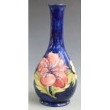 Moorcroft pedestal bottle vase in Hibiscus pattern on a blue ground, H 27cm