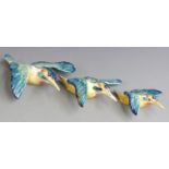 A set of three Beswick graduated kingfisher wall plaques, largest 21cm