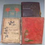 A large collection of postcards in three albums, Edwardian onwards and a tooled leather Carte