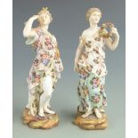 A pair of late 19th/20thC Volkstedt porcelain figurines carrying a garland and a bow and quiver