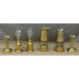 Two Eccles miner's lamps, a pair of brass candlesticks and French oil lamps, tallest 25cm