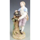 Meissen figure of a man with bird's eggs in his hat, leaning on a tree trump, H 19cm