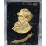 A 19thC gilt metal plaque depicting Charles Dickens with name below, mounted on velvet covered