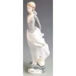 Lladro figure of a girl with basket of flowers at her feet, H 35cm