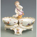 A late 19th/20thC Berlin figural putti double salt/sweetmeat dish decorated with birds and