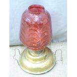 A 19thC brass oil lamp with wide 'ship's style' base and cranberry glass shade, height 52cm