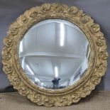 A 19th/20thC butler's / convex mirror in ornate giltwood frame, overall diameter 48cm