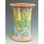 A 19thC Majolica garden seat with sheaves of wheat, corn and basket weave decoration, probably