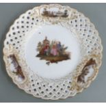 A 19thC Meissen pierced cabinet plate decorated with Watteau scenes, diameter 24cm