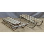 Two vintage sledges, one by Harrods, length 103cm