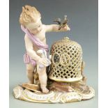 Meissen figure of a boy with birds, blue crossed swords, mark to base, H 12cm