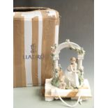 Lladro figurine seated beneath an arbour with dog "Tranquillity", still attached to transportation