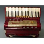 Marinucci 120 bass piano accordion with six treble couplers and one bass coupler, in red pearloid