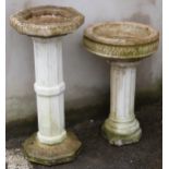 Two garden bird baths with fluted column supports, height of taller 75cm