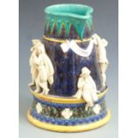 A large 19thC majolica jug or pitcher with applied figural decoration of courting couples drinking
