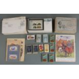 A collection of first day covers and cigarette cards